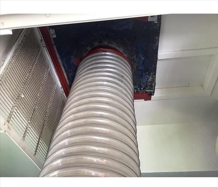 SERVPRO tubing connected to ductwork opening