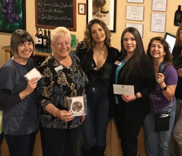 Women posing in local retailer