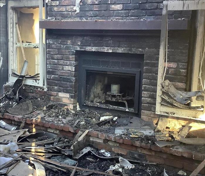 Fireplace with debris and fire damage 